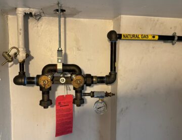 Natural gas piping and meter bar with red lockout tag