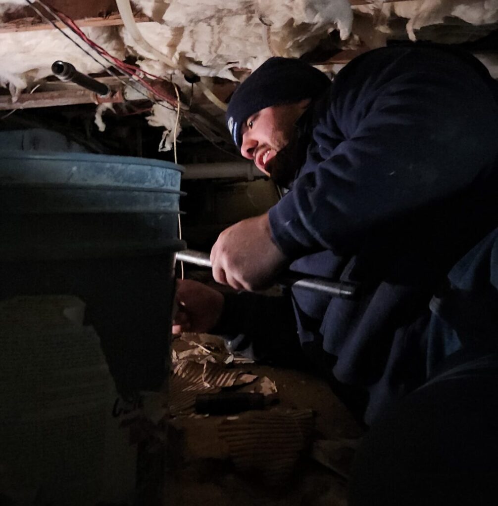 Ariel Services, Inc. Plumber repairing gas pipe in crawlspace
