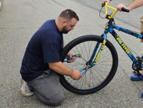Plumber helping stranger fix their bicycle