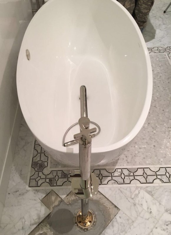 Oval tub with free standing faucet
