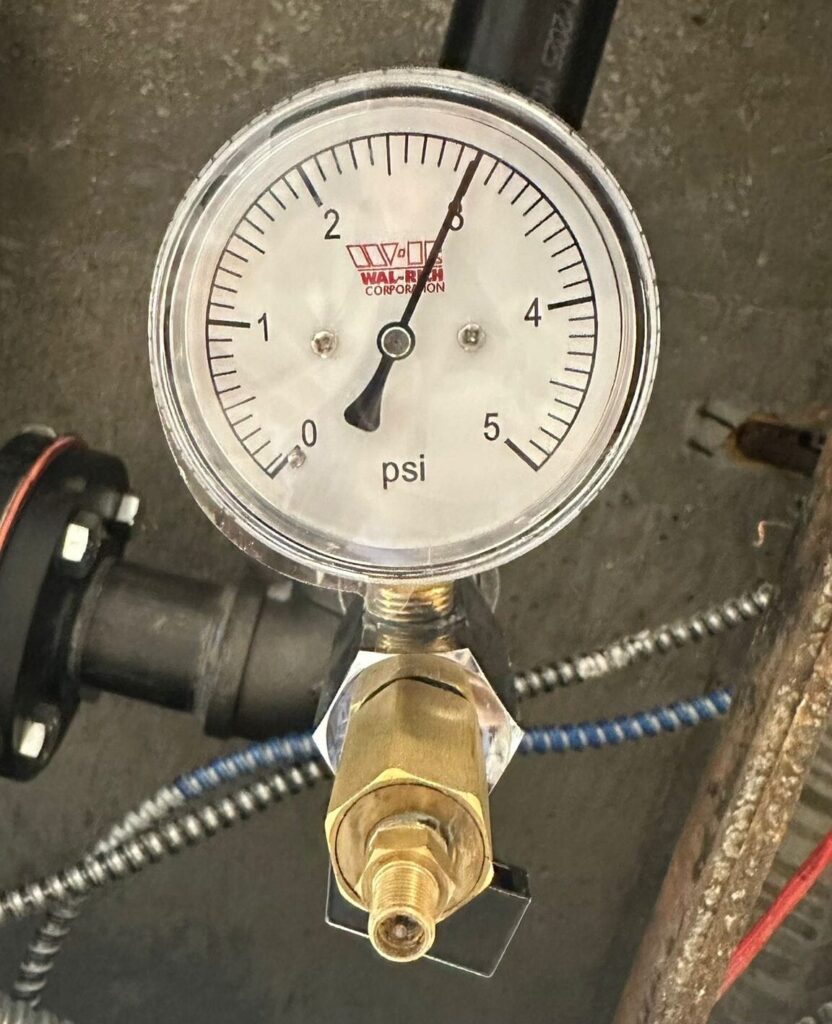 Performing gas integrity test on gas riser, pressure gauge attached reads 3 psi