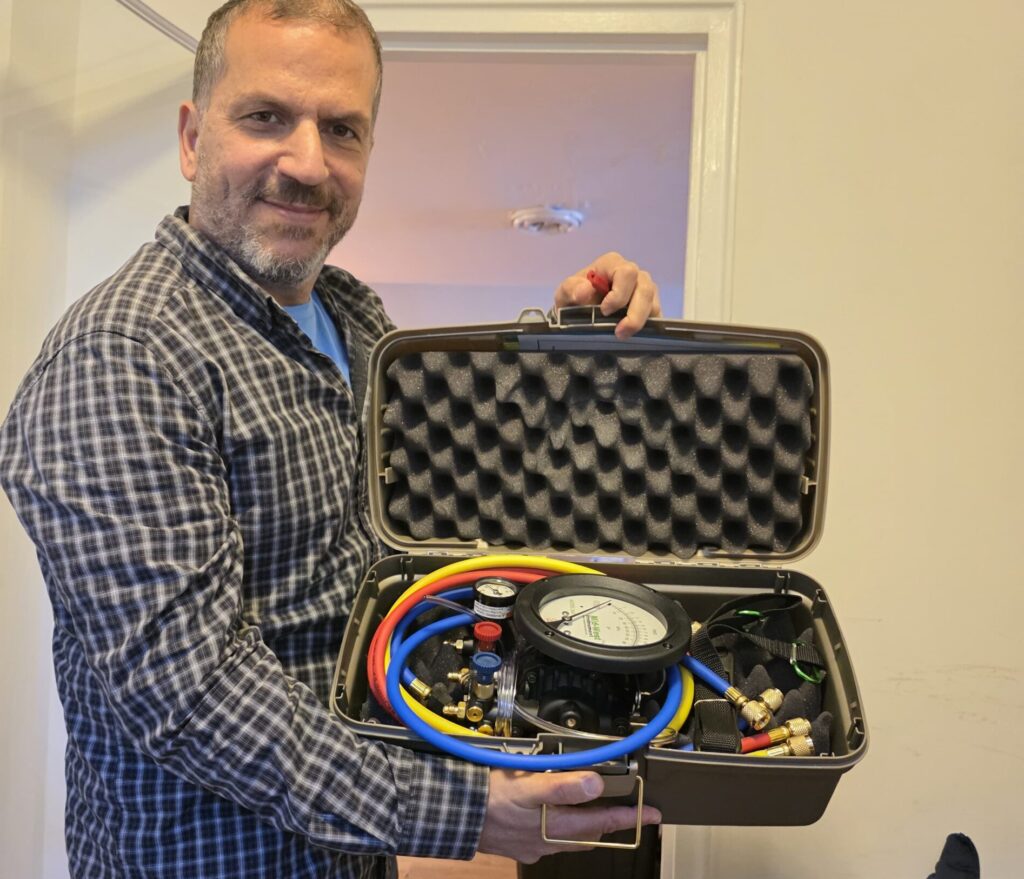 Master plumber holding backflow prevention tester equipment
