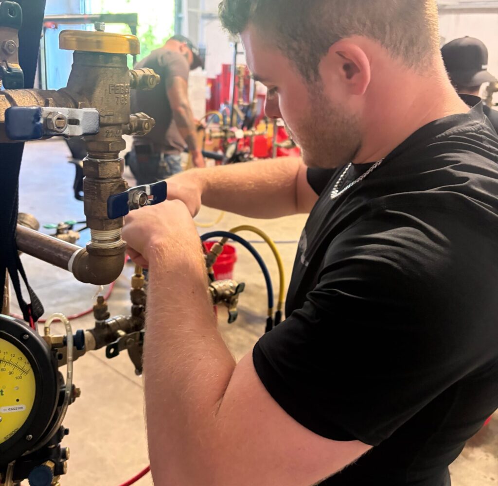 Ariel Services employee completing backflow prevention tester training