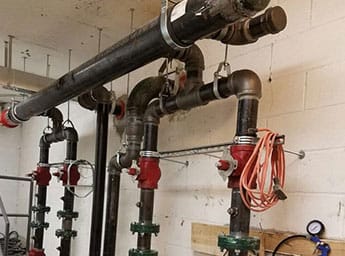 Industrial fire suppression piping with valves in a mechanical room